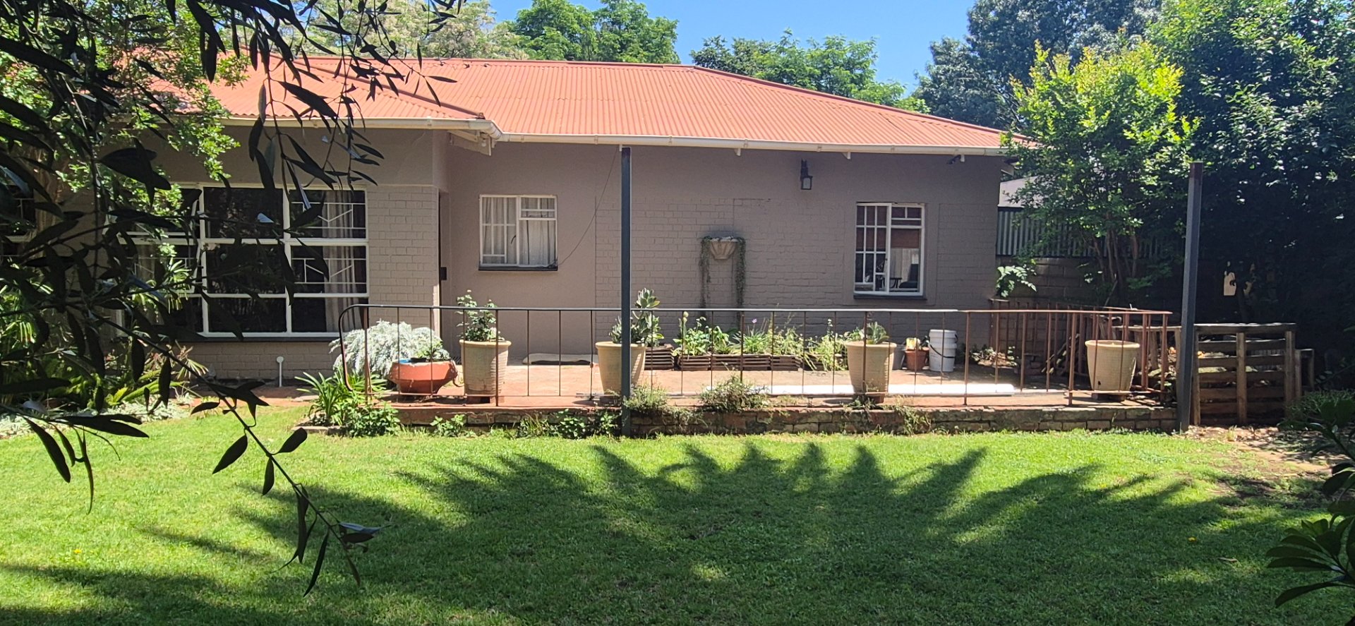 Spacious family home with open-plan living, double garage, pool, and flatlet potential